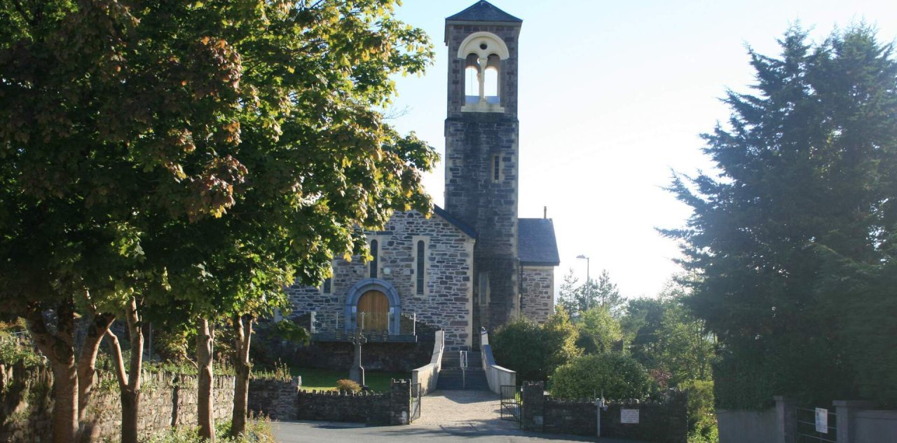 stone church beside trees