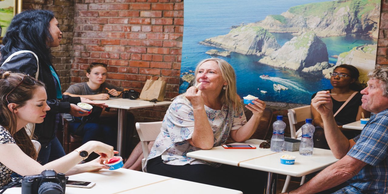 People sitting at tables in cafe chatting