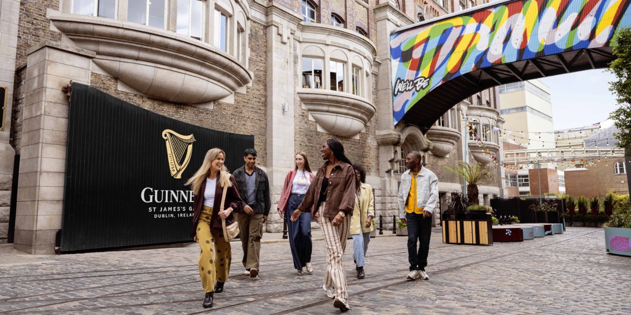 People leaving the Guinness Storehouse passing in front of the famous Guinness Gates 