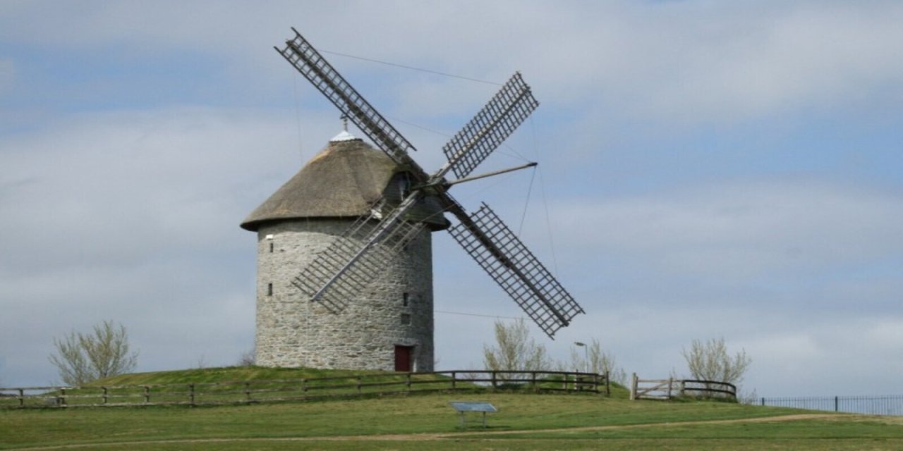 Grey brick wind mills with blue sky background