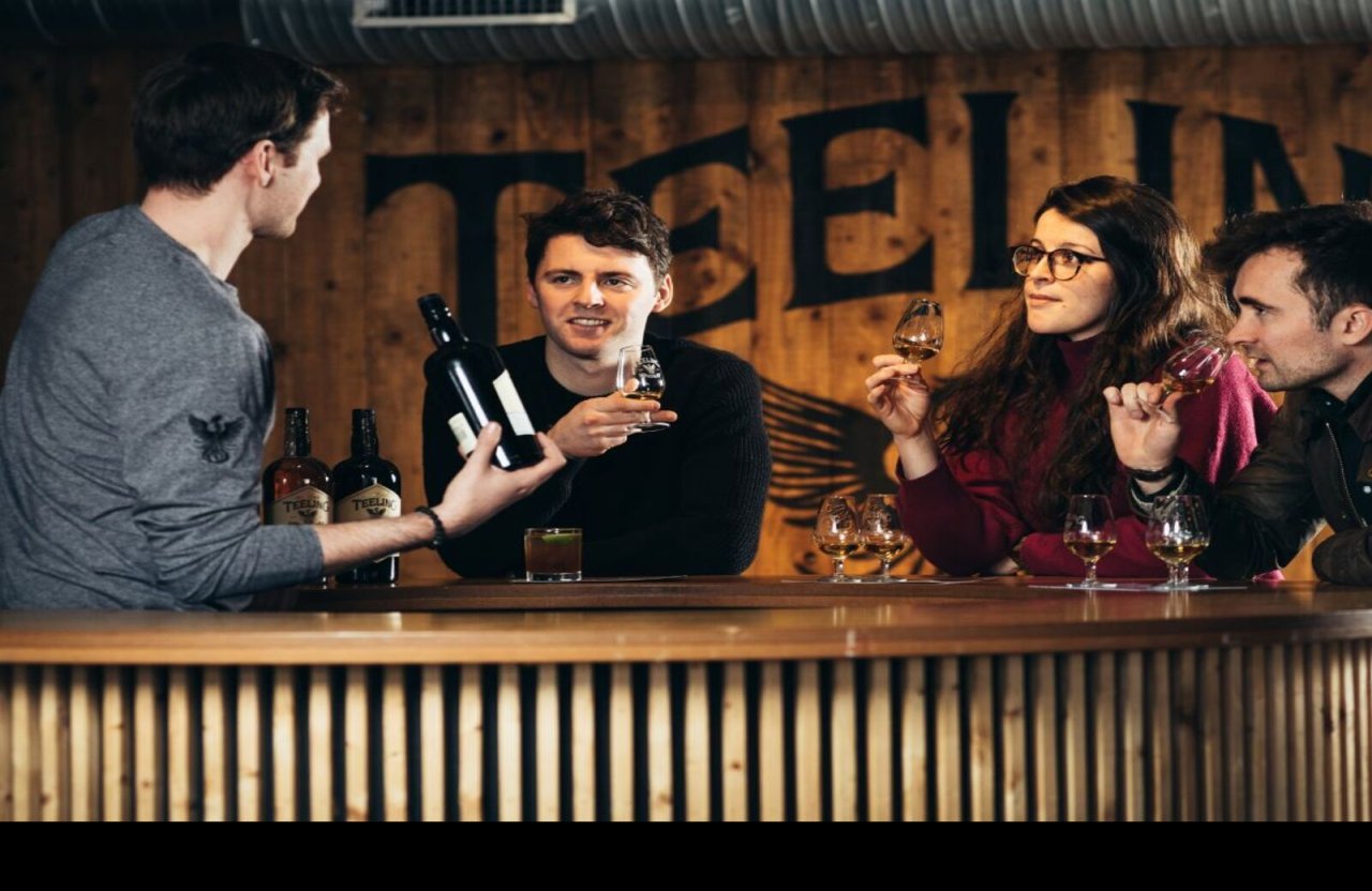 3 people tasting whiskey with barman